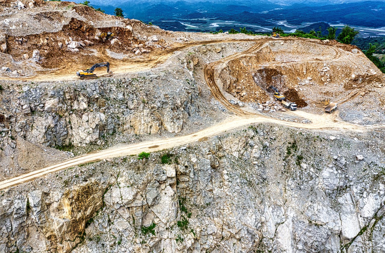 Aerial view of a quarry with heavy machinery in Purwakarta, West Java, Indonesia.